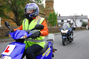 Learning how to use the roads with a moped with expert direction from a 90-ONE instructor.